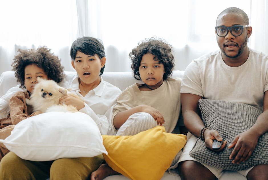 Family watching television through IPTV service on multiple devices simultaneously in modern living room